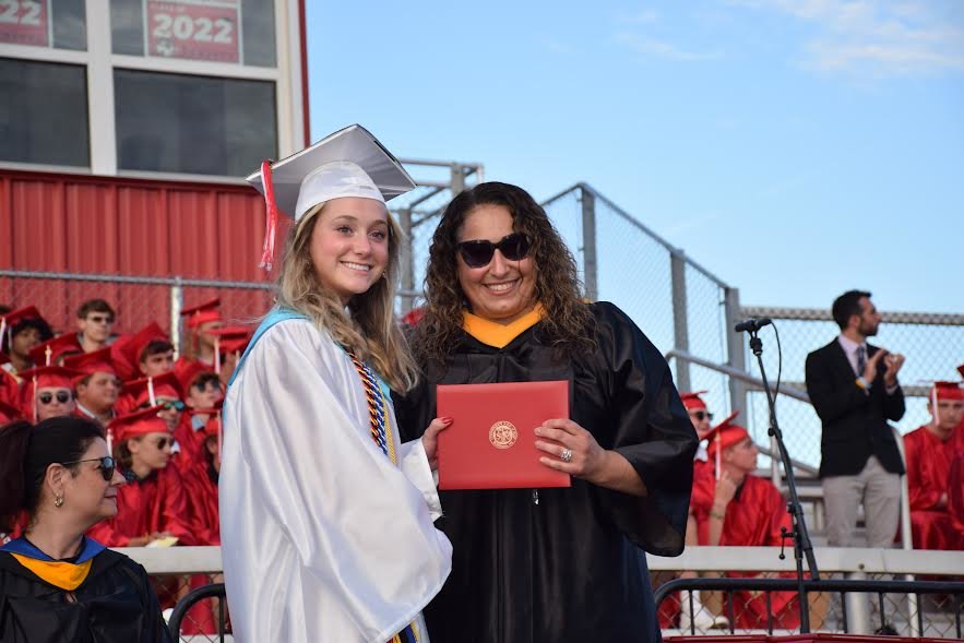 Connetquot High School senior Ella LeBrun received her diploma from Board of Education trustee Jaclyn Napolitano-Furno during the commencement exercises.